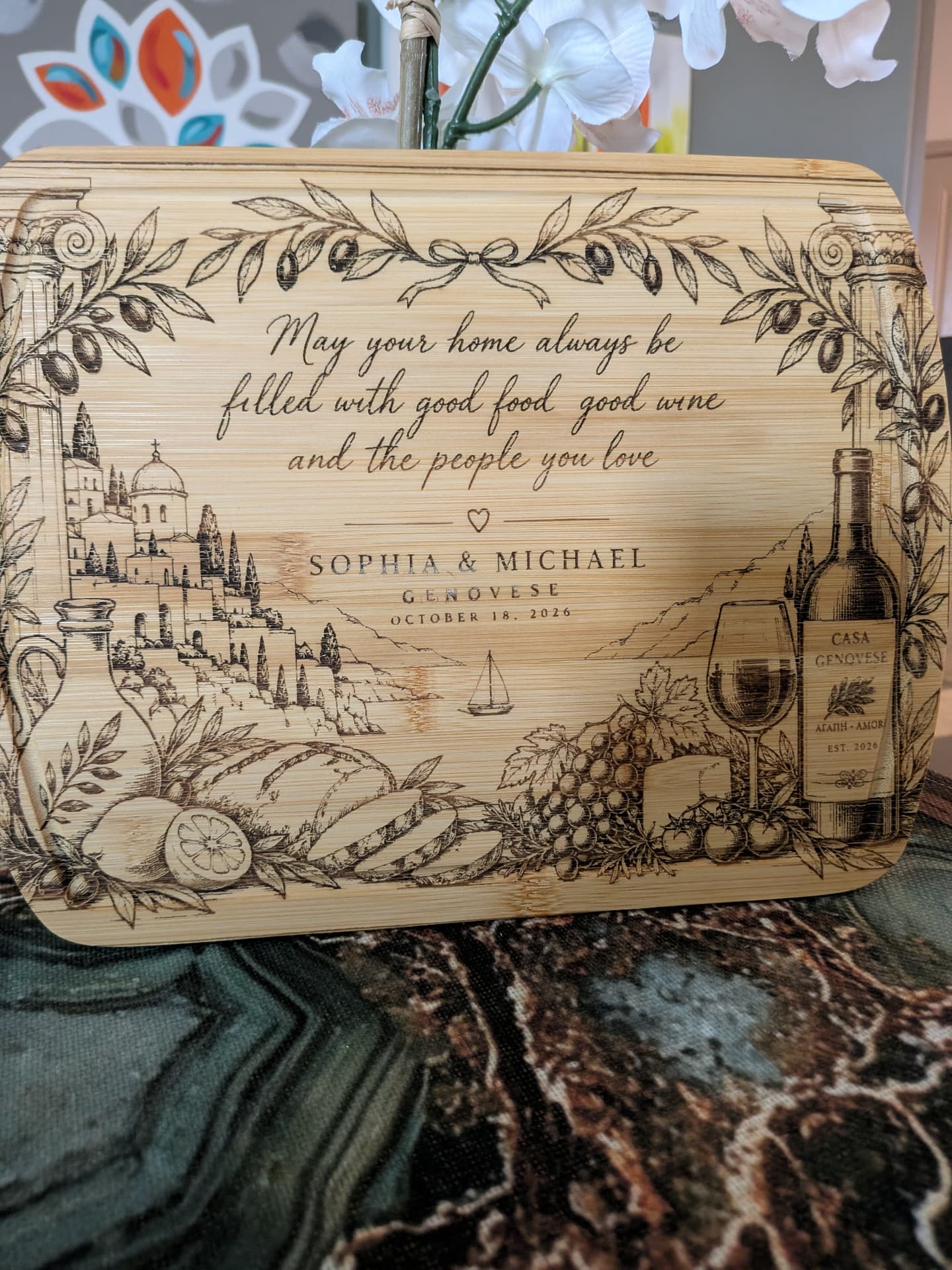 Engraved cutting board with an Italian coastal scene, bread, wine, and the names Sophia & Michael Genovese